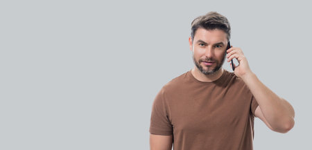 Man using mobile phone isolated over studio background. Man using smart phone cellphone for calls,...