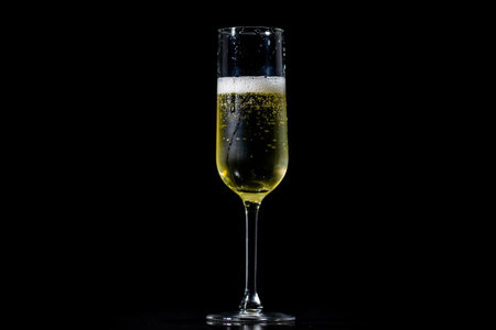 Festive pour of champagne with bubbles. Sparkling wine with bubbly champagne in luxury glass. Splash of champagne for party celebration.の写真素材