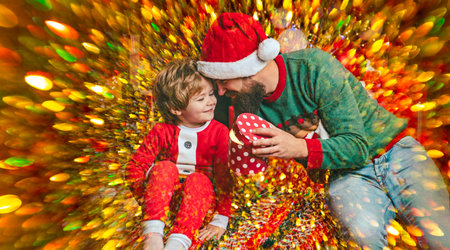 Christmas family moment full of love. Father and son open Christmas gifts together. Christmas father and son enjoy winter holiday. Dad and son create Christmas memories.の写真素材