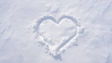 Snow heart. Romantic winter pattern. Heart symbol in snow. Snowy heart banner for winter design. Heart shape in snow.の写真素材