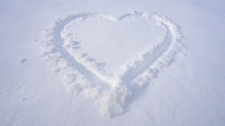 Snow heart on a snow. Love winter background. Heart symbol in snowfall. Heart on snowy ground. Winter love. Snow heart background.の写真素材