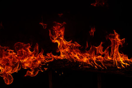 Fire blaze flames on black background. Fire burn flame isolated, abstract texture. Flaming explosion...
