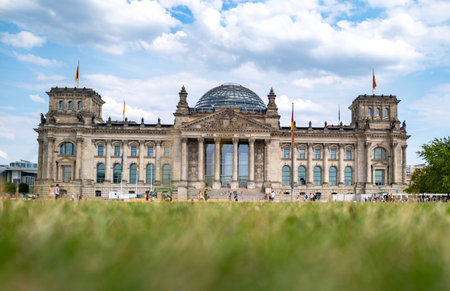 Reichstag view from grass field. Historic German parliament. Travel landmark in Berlin. Front view of Reichstag building. Historic Reichstag architecture in Berlin.の写真素材
