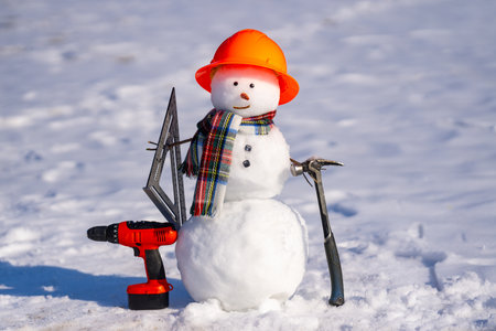 Snowman advert shows winter hardware store gear. Hardware store in winter. Cute snowman advertises seasonal hardware sale.の写真素材