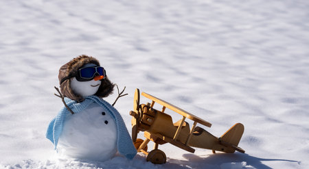 New Year gift delivery with snowman. Winter snowman pilot scene. Winter travel concept with snowman. Holiday snowman with toy airplane.の写真素材
