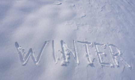 Snowy banner design in cold weather. Frosty winter text outdoors. Winter text with snowflakes. Snow background with winter text.の写真素材