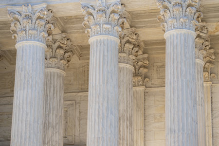 Government building with timeless architecture. Court house exterior with elegant columns. Historic structure showing monumental design. Architecture shaped by strong stone columns.の写真素材