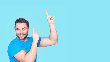 Man points gesture. Portrait of mature man with pointing on copy space or advertising. Man pointing on space for text. Pointing gesture.の写真素材