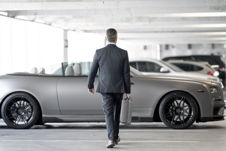 Mature businessman. Rich business man enjoying success. Luxury business. Rich man front of expensive car. Luxury business travel. Confident rich businessman in a classic suit.の写真素材