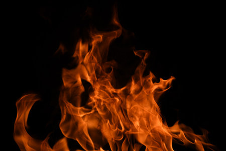 Fire blaze flames on black background. Fire burn flame isolated, abstract texture. Flaming explosion...