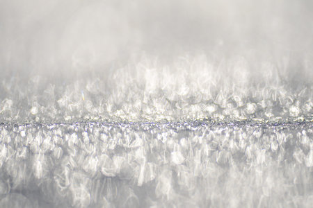Snowy frozen background with snowflakes. White snow surface with natural frost pattern. Winter frost...