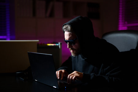 Hacking personal information safety. Crypto data hacking. Hacking hunting for crypto currency. Hacker in hoodie dark night theme. Digital data security concept. Hackers attack.の写真素材
