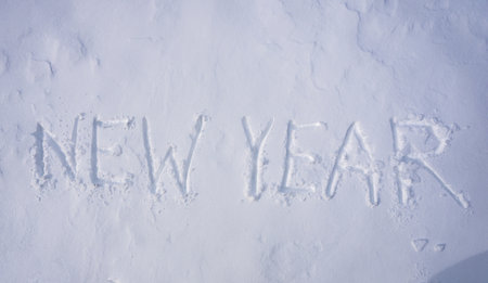 New Year design. Winter text with snow texture. Winter banner design. Snow text on icy surface. Frozen background with snow word. Snowy surface with clean winter banner.の写真素材