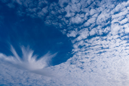 Bright blue summer sky with fluffy white clouds. Calm and serene skyscape background photo. Sky cloud background. Panorama of cloudy sky. White clouds in the blue sky.の写真素材