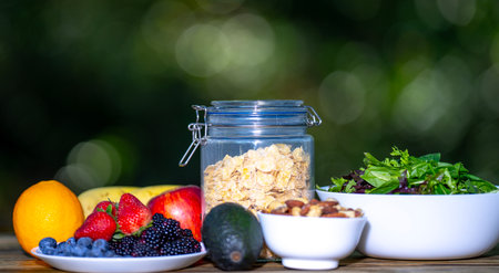 Fresh fruit assortment served in a bowl for breakfast. Granola and muesli blend with berries. Healthy food breakfast with natural oatmeal and fruit. Healthy lunch dish with fresh fruit on green.の写真素材