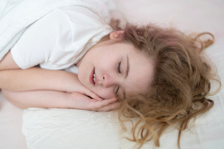 Kid sleep face close up. Kid sleep peacefully at home bed. Kid sleep in a cozy bed. Kid sleep calm bedtime.の写真素材