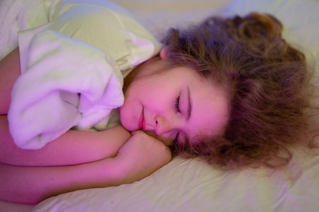 Kid sleep calm on bedtime. Child sleeping with soft pillow.の写真素材