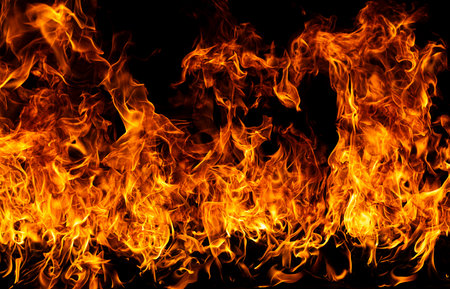 Fire abstract background with flame. Intense burning fire texture for overlay layer effects. Fiery explosion background. Flame pattern. Flames on black backdrop. Glowing flames on black background.の写真素材