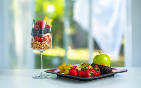 Morning breakfast with natural oatmeal and fruit. Healthy lunch. Fruit cocktail served in a stylish glass cup.の写真素材
