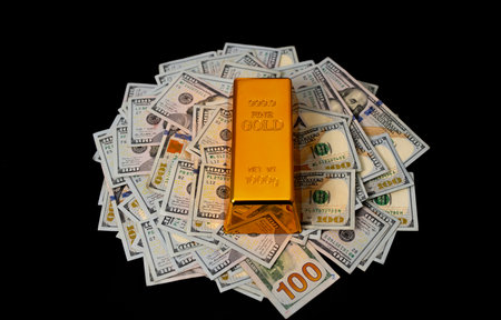 Gold bar and money. Gold bars for savings capital. Dollars money and gold concept.の写真素材