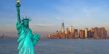 New York City landmark with famous monument. Liberty statue above NYC. Statue of Liberty in NYC, USA. Liberty statue before New York City skyline. New York City skyline.の写真素材