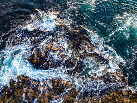 Clear waves. Waves with foam. Crashing waves aerial. Scenic waves top view.