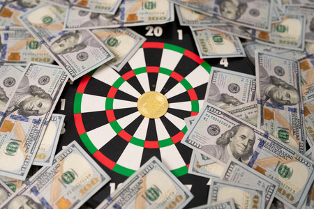 Goal and money concept with dart hitting target. Financial success with dollars and banknotes. Investment and money growth. American finance and income. Credit, loan, and payment strategy with USD.の写真素材