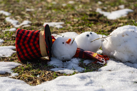 Snowman wait spring. Snowman is melting on spring day. Winter and spring, warm winter. Melted snow, winter weather, anomaly weather concept. Spring time. Winter season.の写真素材
