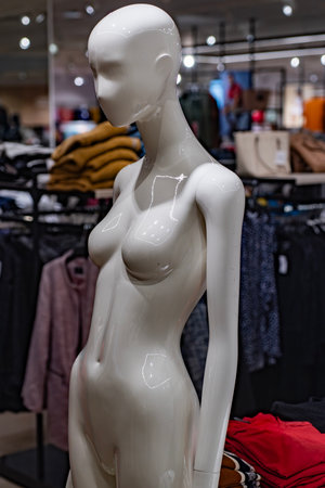 Female mannequin in fashion store. Shiny abstract figure under bright lights. Modern art of retail...
