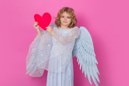 Little angel with heart symbol love and valentines day. Little cute child at angel costume on...