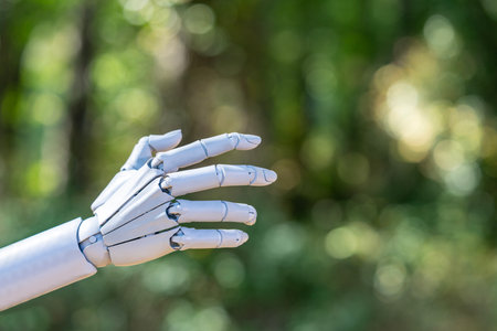Robot hand. Robot touching concept on green nature background. Ai hand connection. Robotic hands concept.の写真素材