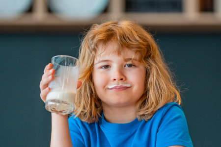 School child having milk snack break. Healthy nutrition concept with kid and milk. Child drinking milk in modern kitchen.の写真素材
