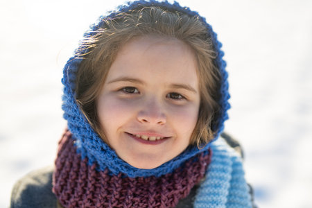 Cute kid outdoors portrait in winter. Child winter lifestyle portrait. Cute kid in snow. Happy...