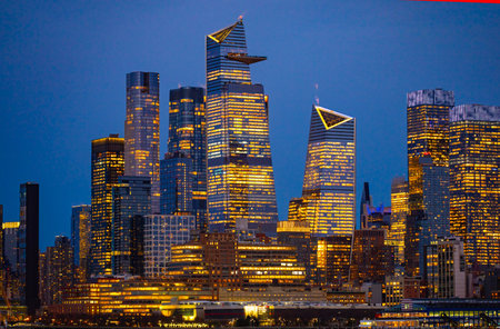 . New York City skyline over river. New York City illuminated buildings. New York City modern...