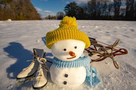 Snowman standing in fresh snow. Christmas snowman decoration outdoors. Funny snowman on snowy...