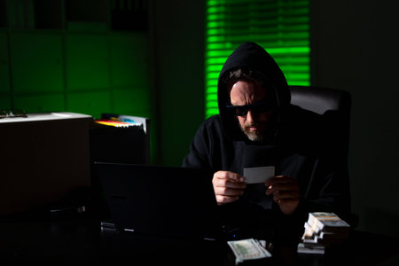 A digital thief transfers files in a night office. Cybercrime investigator and online fraud alert....