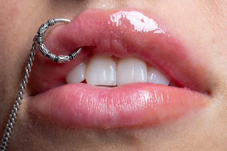 Piercing lips macro beauty detail. Piercing lips silver jewelry closeup. Piercing lips fashion style...