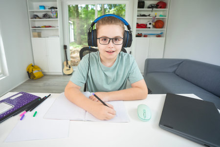 Back to school. Child with laptop at home. Student sitting at desk during distance school class....