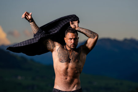 Muscular man portrait with powerful body. Muscular body concept with training lifestyle. Muscular...