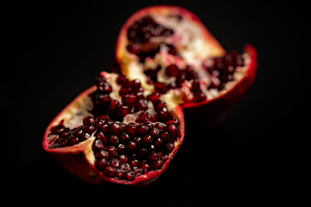 Pomegranate arils on red plate. Fresh pomegranate. Red pomegranate. Pomegranate seeds.