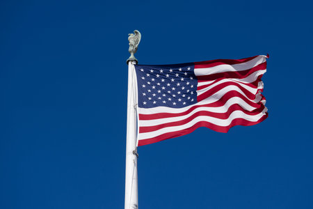 Flag American waving in bright sky. American patriotic banner on liberty flag. USA democracy freedom...