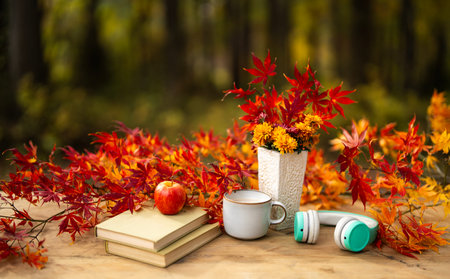 Beautiful autumn table setting for thanksgiving. Cozy fall atmosphere. Romantic autumn mood. Autumn fall composition. Tea and books create a peaceful fall atmosphere. Autumn relaxation.