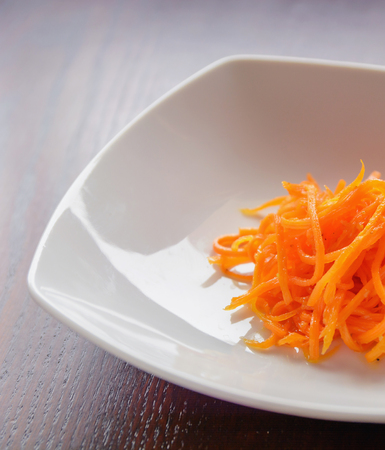 grated orange julienne fresh carrots on the plateの写真素材