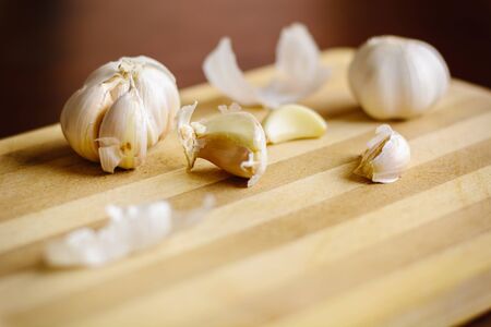 brown Garlic on the bamboo wooden backgroundの写真素材