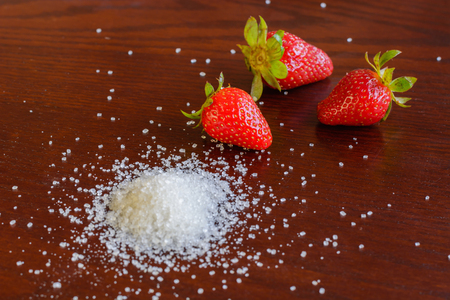 red jucy strawberry with white sugar on the tableの写真素材