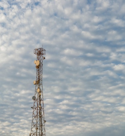 Antenna tower and blue sky with white cloudの写真素材