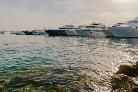 Reflections of the water on the hull of boat anchored at a marinaの写真素材