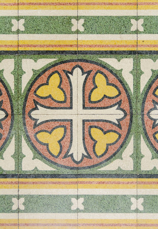 tiles on the floor in an ancient form of a cross and floral ornament