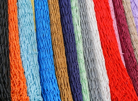 colorful grid of cord hanging vertically in the form of multi-colored backgroundの写真素材