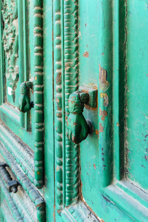 Door knob - vintage. Old door with white and green thread and the handleの写真素材